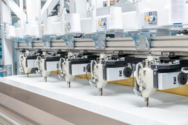 The quilting module is equipped with twelve modified servo-driven lock stitch sewing heads.