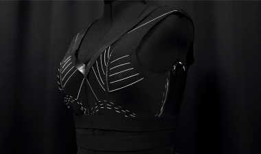 Adaptive sports bra made by embroidery that tightens when the user begins exercising.