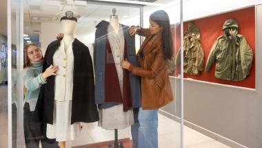 Tabitha Mueller-Schrader ’26, left, and Maya Abrol ’26 prepare nurses uniforms for the exhibition.