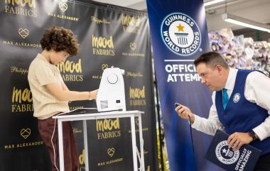 Under the close watch of a Guinness World Records adjudicator, 10-year-old designer Max Alexander competes during his launch event at Mood Fabrics NYC on September 14, 2026. 